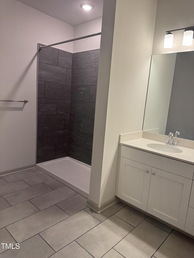 2418 Gathering Square Ct, Fuquay Varina, NC 27526 - full bath with baseboards, tiled shower, vanity, and tile patterned flooring