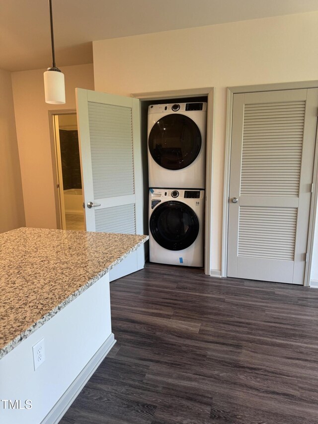 2418 Gathering Square Ct, Fuquay Varina, NC 27526 - clothes washing area with stacked washer / dryer, laundry area, and dark wood-style floors