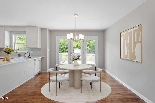 5612 Sandy Trail Dr, Knightdale, NC 27545 - dining area with a chandelier, baseboards, and dark wood-type flooring