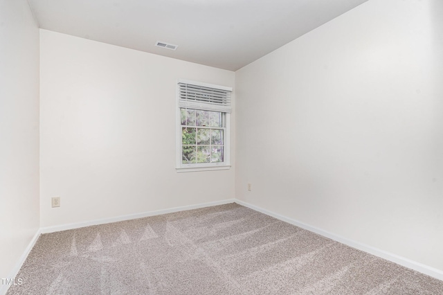 carpeted spare room with baseboards