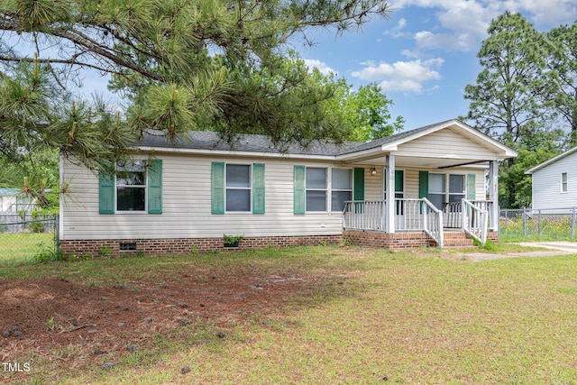 manufactured / mobile home with a porch, crawl space, fence, and a front lawn