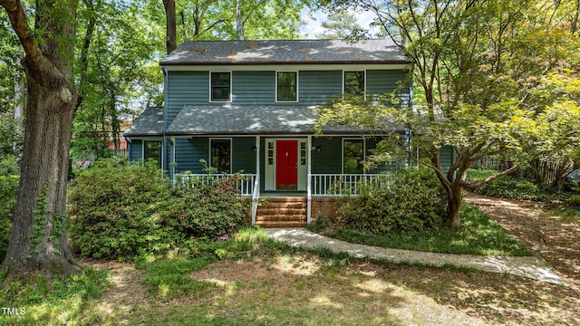 view of front of house featuring covered porch and a shingled roof