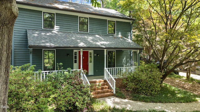 view of front of house with a porch and roof with shingles