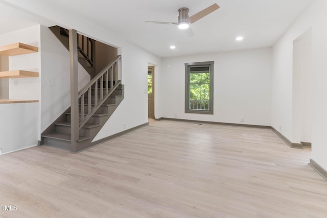 unfurnished living room with stairway, wood finished floors, ceiling fan, recessed lighting, and baseboards
