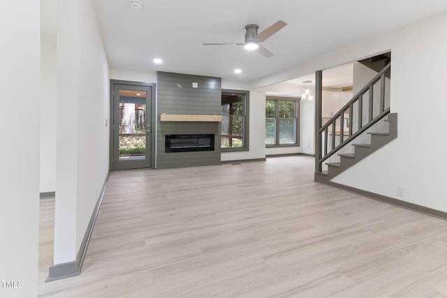 unfurnished living room featuring baseboards, light wood-style flooring, ceiling fan, and recessed lighting