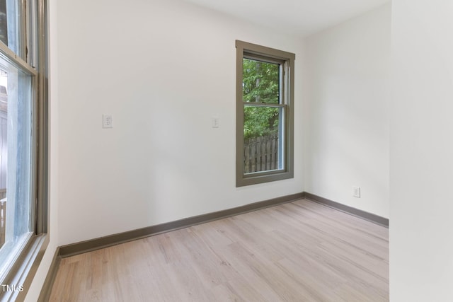 empty room with wood finished floors and baseboards