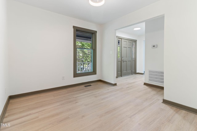 empty room featuring light wood-style floors and baseboards