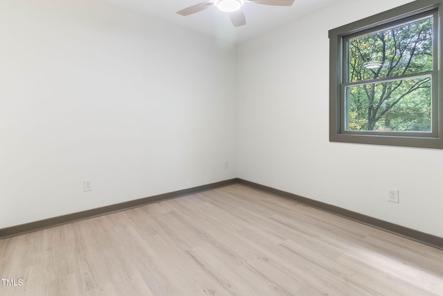 empty room with light wood-type flooring, ceiling fan, and baseboards