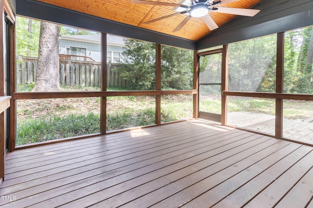 unfurnished sunroom with ceiling fan and vaulted ceiling