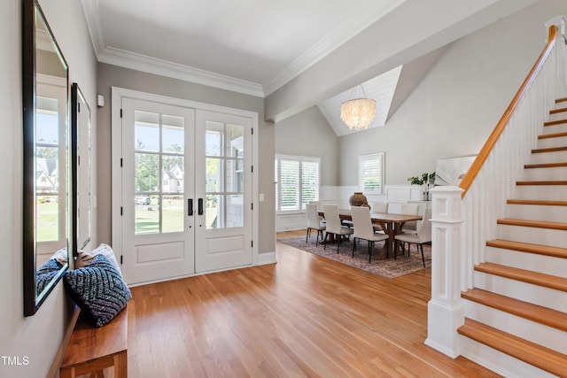 6 Castlewood Dr, Durham, NC 27713 - entryway featuring french doors, stairs, light wood-type flooring, vaulted ceiling, and a chandelier
