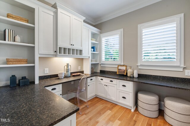 6 Castlewood Dr, Durham, NC 27713 - kitchen with open shelves, built in desk, white cabinets, crown molding, and light wood-style flooring
