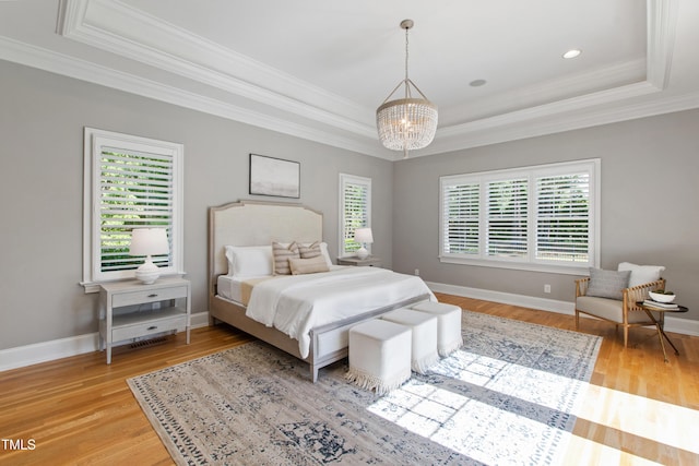 6 Castlewood Dr, Durham, NC 27713 - bedroom with a raised ceiling, a chandelier, crown molding, and light wood-type flooring