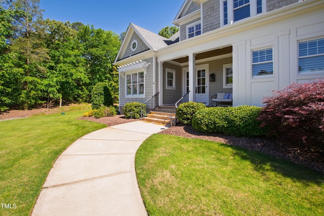 6 Castlewood Dr, Durham, NC 27713 - view of exterior entry with a yard and covered porch