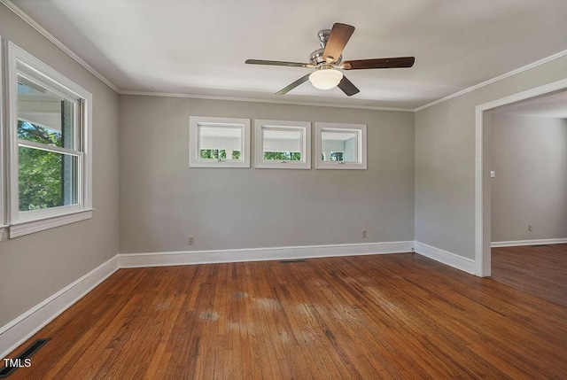 unfurnished room with crown molding, baseboards, a ceiling fan, and hardwood / wood-style floors