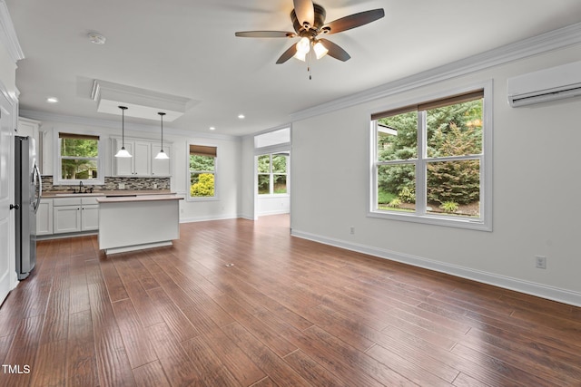 109 Rustler Rd, Louisburg, NC 27549 - kitchen with ornamental molding, open floor plan, freestanding refrigerator, ceiling fan, and a wall mounted air conditioner