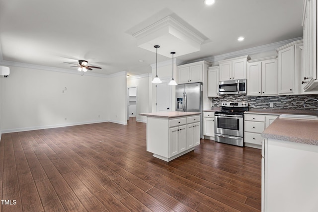 109 Rustler Rd, Louisburg, NC 27549 - kitchen featuring stainless steel appliances, a ceiling fan, backsplash, ornamental molding, and white cabinetry
