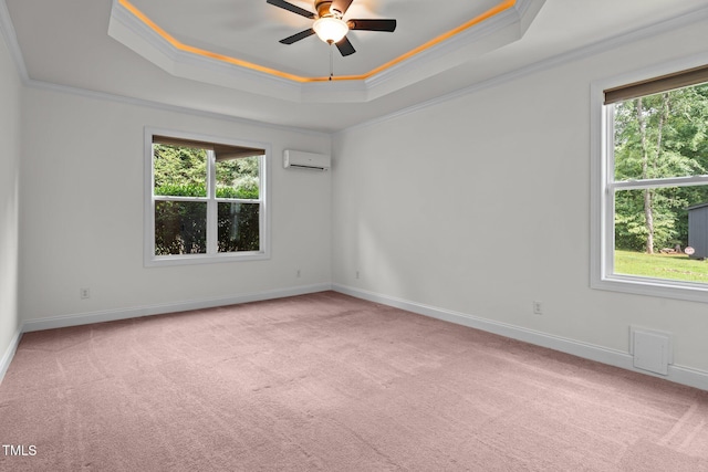 109 Rustler Rd, Louisburg, NC 27549 - spare room with a tray ceiling, an AC wall unit, plenty of natural light, carpet, and crown molding