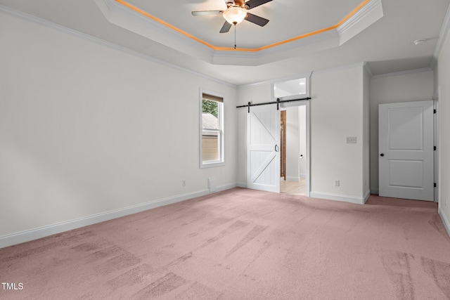 109 Rustler Rd, Louisburg, NC 27549 - unfurnished bedroom featuring carpet floors, crown molding, a raised ceiling, and a barn door