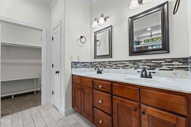 109 Rustler Rd, Louisburg, NC 27549 - bathroom featuring crown molding, double vanity, tasteful backsplash, and a spacious closet