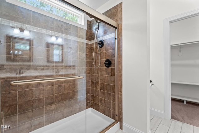 109 Rustler Rd, Louisburg, NC 27549 - bathroom featuring a shower stall, a spacious closet, and tile patterned floors