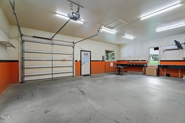 109 Rustler Rd, Louisburg, NC 27549 - garage featuring a garage door opener and a workshop area
