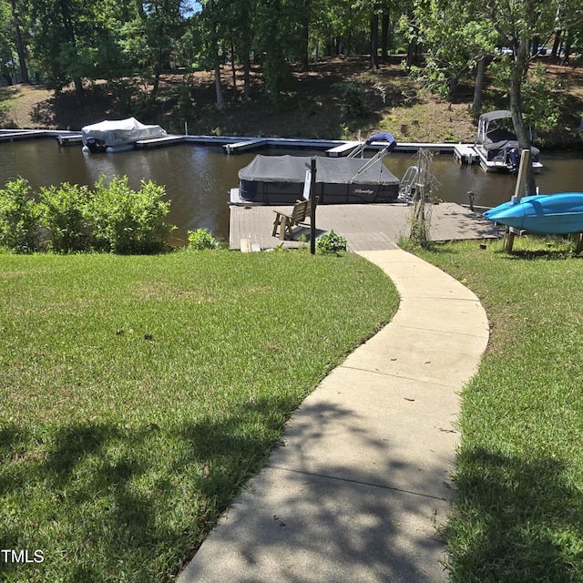 exterior space featuring a lawn, a boat dock, and boat lift
