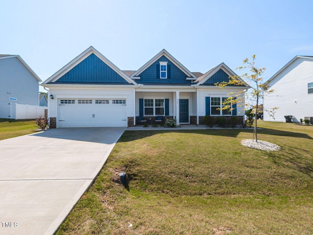 craftsman house featuring concrete driveway, an attached garage, board and batten siding, and a front yard