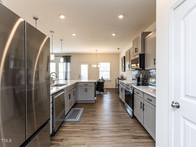 kitchen with recessed lighting, a sink, dark wood finished floors, and stainless steel appliances