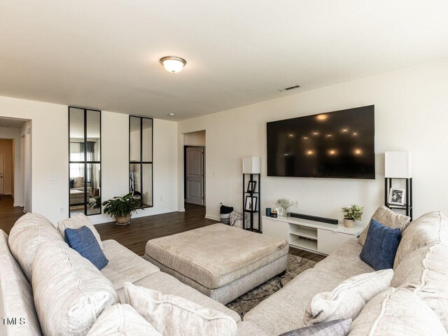 living room featuring wood finished floors and visible vents
