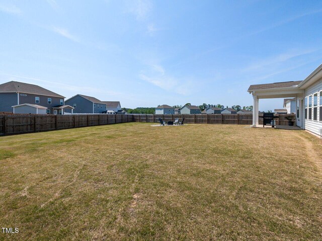 view of yard featuring a residential view and a fenced backyard
