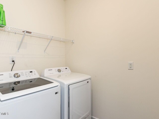 clothes washing area with laundry area and washer and dryer