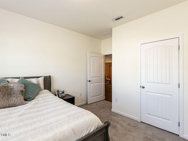 bedroom featuring carpet flooring, baseboards, and visible vents