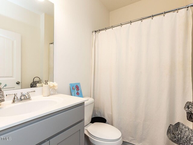 full bathroom featuring vanity and toilet