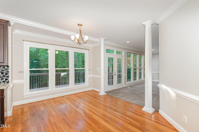 unfurnished dining area featuring crown molding, baseboards, and light wood-style floors