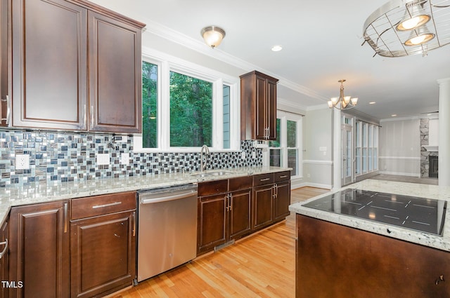 kitchen featuring stainless steel dishwasher, tasteful backsplash, light stone counters, a sink, and light wood finished floors