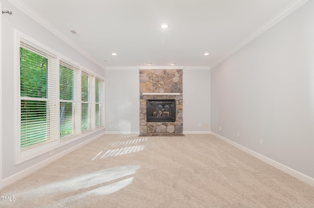 unfurnished living room with carpet flooring, crown molding, baseboards, and a fireplace