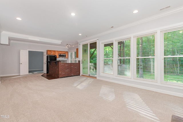 unfurnished living room featuring recessed lighting, light colored carpet, ornamental molding, and visible vents
