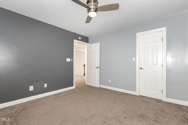 unfurnished bedroom featuring baseboards, a ceiling fan, and carpet