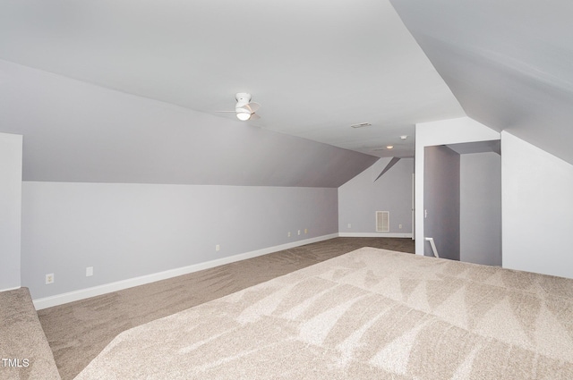 additional living space featuring baseboards, lofted ceiling, and carpet