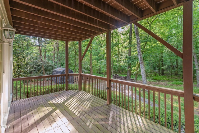 deck with a view of trees and a shed