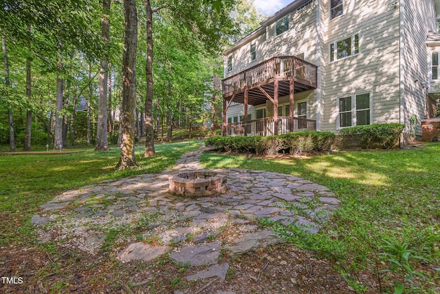 view of yard with a patio, a fire pit, and a wooden deck