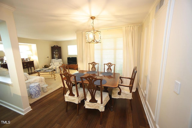 dining space with baseboards, dark wood finished floors, and a notable chandelier