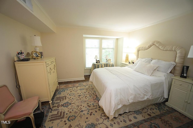 bedroom with crown molding and baseboards