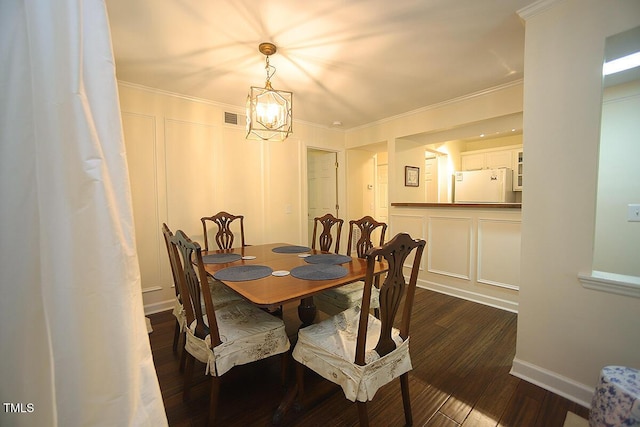 dining area with crown molding, an inviting chandelier, baseboards, dark wood-type flooring, and visible vents