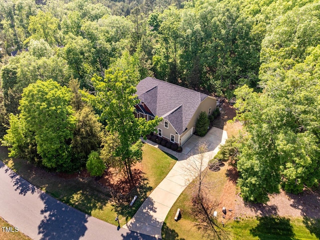 birds eye view of property with a view of trees