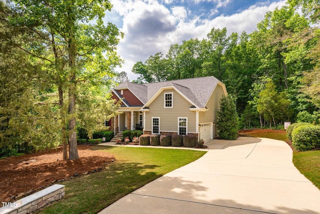 craftsman house featuring driveway, a shingled roof, a front yard, and a garage