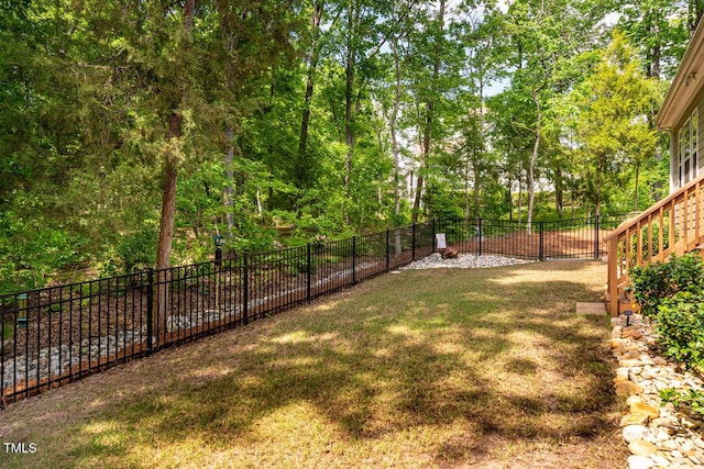 view of yard featuring a fenced backyard and stairs