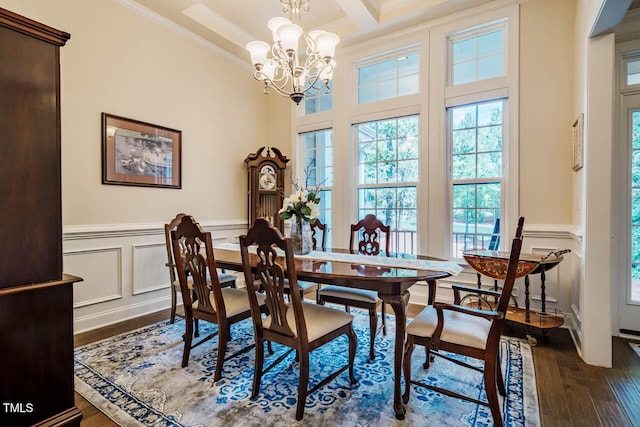 dining space with crown molding, dark wood-style floors, plenty of natural light, and an inviting chandelier