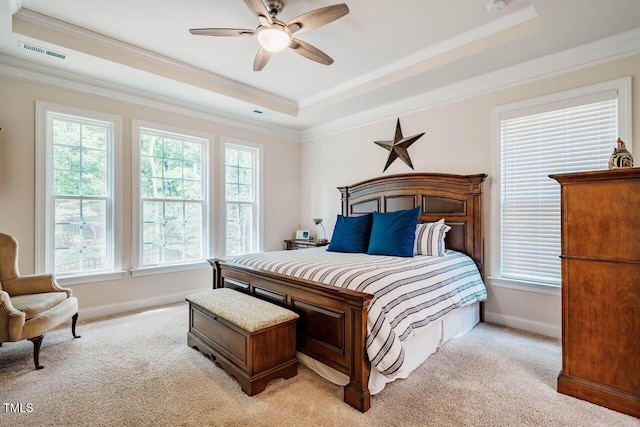 bedroom with a raised ceiling, baseboards, light carpet, and visible vents