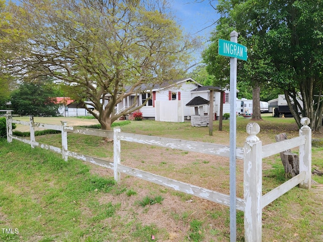 bungalow-style house featuring fence and a front lawn